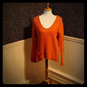 Orange sweater with beaded embellishments